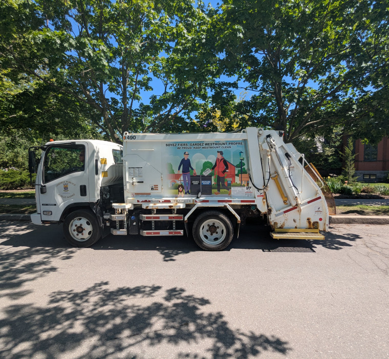 Waste collection truck on a summer day