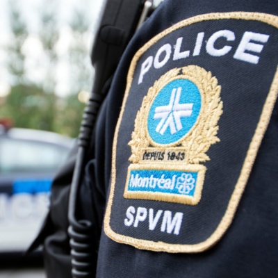 the Montreal Police Force logo on an agent's uniform