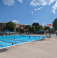 Pool during summer with people and a lifeguard