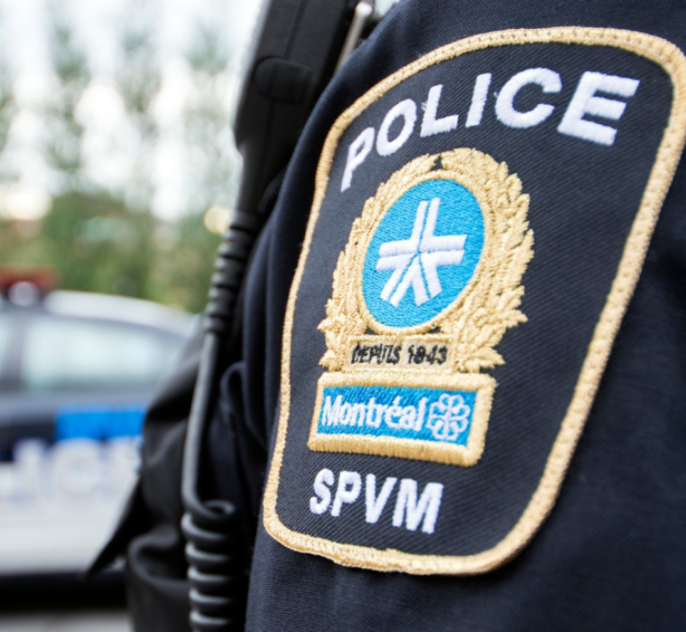 the Montreal Police Force logo on an agent's uniform