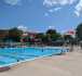 Pool during summer with people and a lifeguard