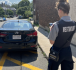 A Public Safety agent observes a parked vehicle